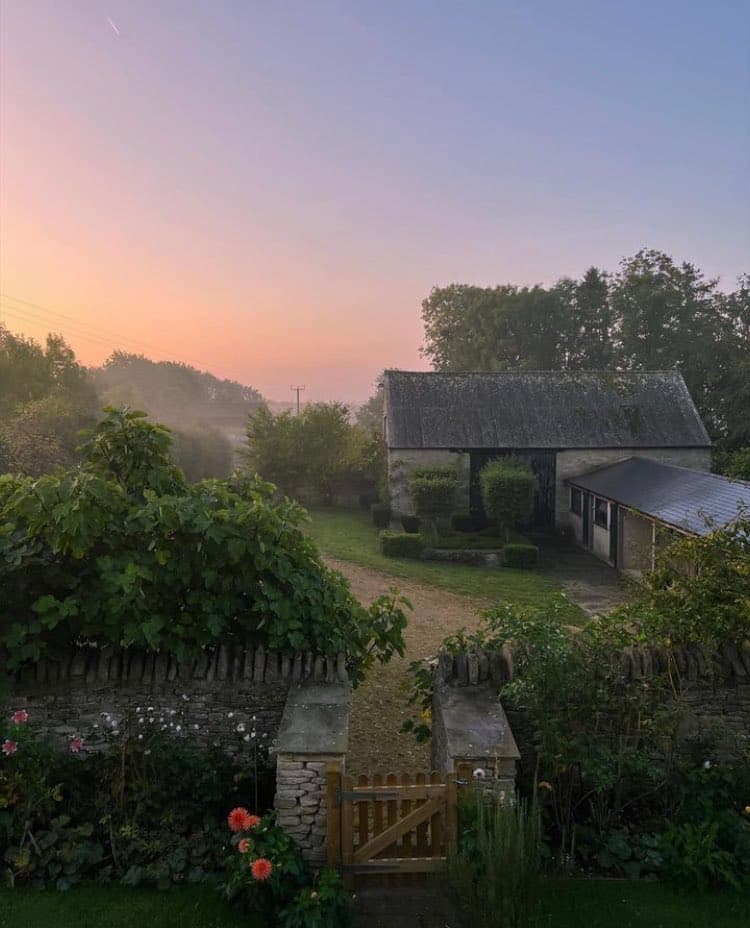 a misty countryside with outbuildings